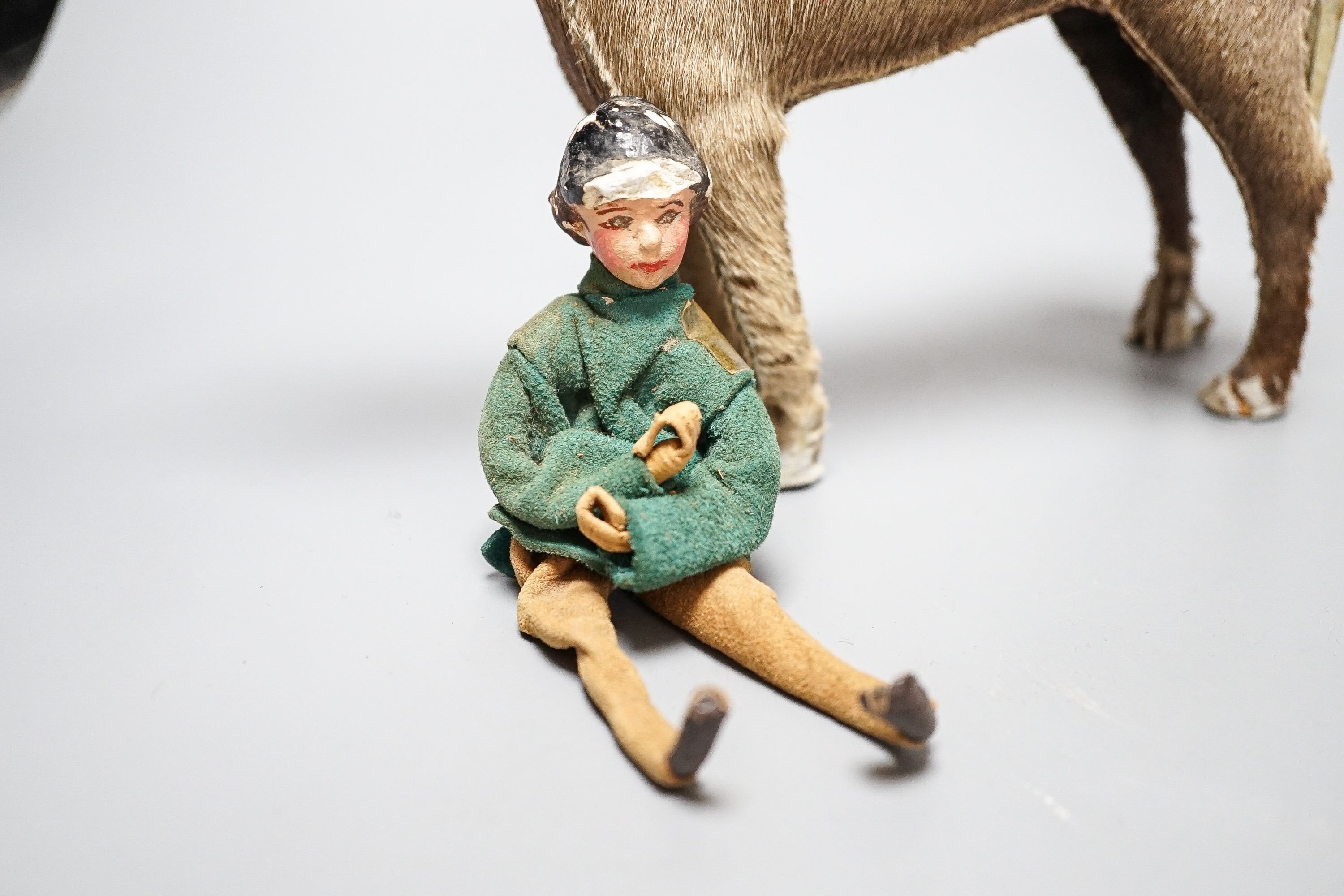 Two Edith Reynolds handmade real skin and leather horse models, 18cm high, together with a female jockey and related leather accessories